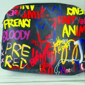 Handheld cosmetic bag with graffiti print and gold zipper